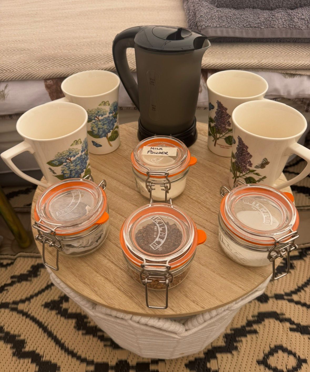 Welcome tea tray with kettle, mugs and Kilner jars in the family glamping teepee at Ghyll House Campsite